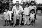 Khmer Rouge leader Saloth Sar, aka Pol Pot, sitting with group of children at Anlong Veng c.1990. The child on his lap is probably Pol Pot's daughter. Others may be his grandchildren, or those of other senior Khmer Rouge cadre. Photo probably by senior KR official.