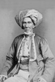 This carte-de-visite photograph depicts an Arab in the Dutch colonial capital of Batavia (present-day Jakarta) preparing for the hajj.<br/><br/>

The Arabs in Southeast Asia generally were from the area of Hadramaut in the southern part of Arabia. During the 19th century, the number of Arabs immigrating to Asia increased, but they remained tied to their homeland and often used the wealth acquired in their new homes to finance projects in Arabia. Despite sharing their Muslim faith with native Indonesians, Arabs maintained separate communities, particularly during the colonial period.<br/><br/>

The photograph was taken by the studio of Woodbury & Page, which was established in 1857 by the British photographers Walter Bentley Woodbury and James Page.