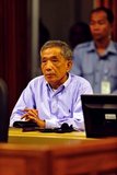 Kang Kek Iew or Kaing Kek Iev, also romanized as Kaing Guek Eav, nom de guerre Comrade Duch or Deuch; or Hang Pin, (born 17 November 1942) is a former leader in the Khmer Rouge communist movement, which ruled Democratic Kampuchea from 1975 to 1979. He is best known for heading the Khmer Rouge special branch and running the infamous Tuol Sleng (S-21) prison camp in Phnom Penh. The first Khmer Rouge leader to be tried by the Extraordinary Chambers in the Courts of Cambodia for the crimes of the regime, he was convicted of crimes against humanity, murder, and torture for his role in the Cambodian Holocaust and sentenced to 35 years' imprisonment.<br/><br/>

Photo by the Extraordinary Chambers in the Courts of Cambodia for the Prosecution of Crimes Committed During the Period of Democratic Kampuchea, commonly known as the Cambodia Tribunal.