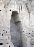 The Buddhas of Bamiyan were two 6th century monumental statues of standing buddhas carved into the side of a cliff in the Bamiyan valley in the Hazarajat region of central Afghanistan, situated 230 km (143 miles) northwest of Kabul at an altitude of 2,500 meters (8,202 ft).<br/><br/>

Built in 507 CE, the larger in 554 CE, the statues represented the classic blended style of Gandhara art. The main bodies were hewn directly from the sandstone cliffs, but details were modeled in mud mixed with straw, coated with stucco. This coating, practically all of which was worn away long ago, was painted to enhance the expressions of the faces, hands and folds of the robes; the larger one was painted carmine red and the smaller one was painted multiple colors.<br/><br/>

The lower parts of the statues' arms were constructed from the same mud-straw mix while supported on wooden armatures. It is believed that the upper parts of their faces were made from great wooden masks or casts. The rows of holes that can be seen in photographs were spaces that held wooden pegs which served to stabilize the outer stucco.<br/><br/>

They were intentionally dynamited and destroyed in 2001 by the Taliban, on orders from leader Mullah Mohammed Omar, after the Taliban government declared that they were ‘idols’. International opinion strongly condemned the destruction of the Buddhas, which was viewed as an example of the intolerance of the Taliban. Japan and Switzerland, among others, have pledged support for the rebuilding of the statues.