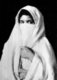 Photograph of a veiled woman - presumably an Arab or Bedouin - of Algeria produced as a souvenir for the nascent European tourist market.