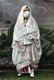 Photograph of a veiled woman - presumably an Arab or Bedouin - of Algeria produced as a souvenir for the nascent European tourist market. market, c.1900.