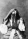 Photograph of a veiiled Arab woman of Algeria produced as a souvenir for the nascent European tourist market.