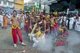 Thailand: Firecrackers explode over shrine bearers and they are quickly enveloped in thick smoke, street procession, Phuket Vegetarian Festival