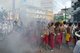Thailand: Firecrackers explode over shrine bearers and they are quickly enveloped in thick smoke, street procession, Phuket Vegetarian Festival