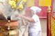 Thailand: An elderly woman helps clean incense sticks away during the height of the festivities, San Chao Chui Tui (Chinese Taoist temple), Phuket Vegetarian Festival